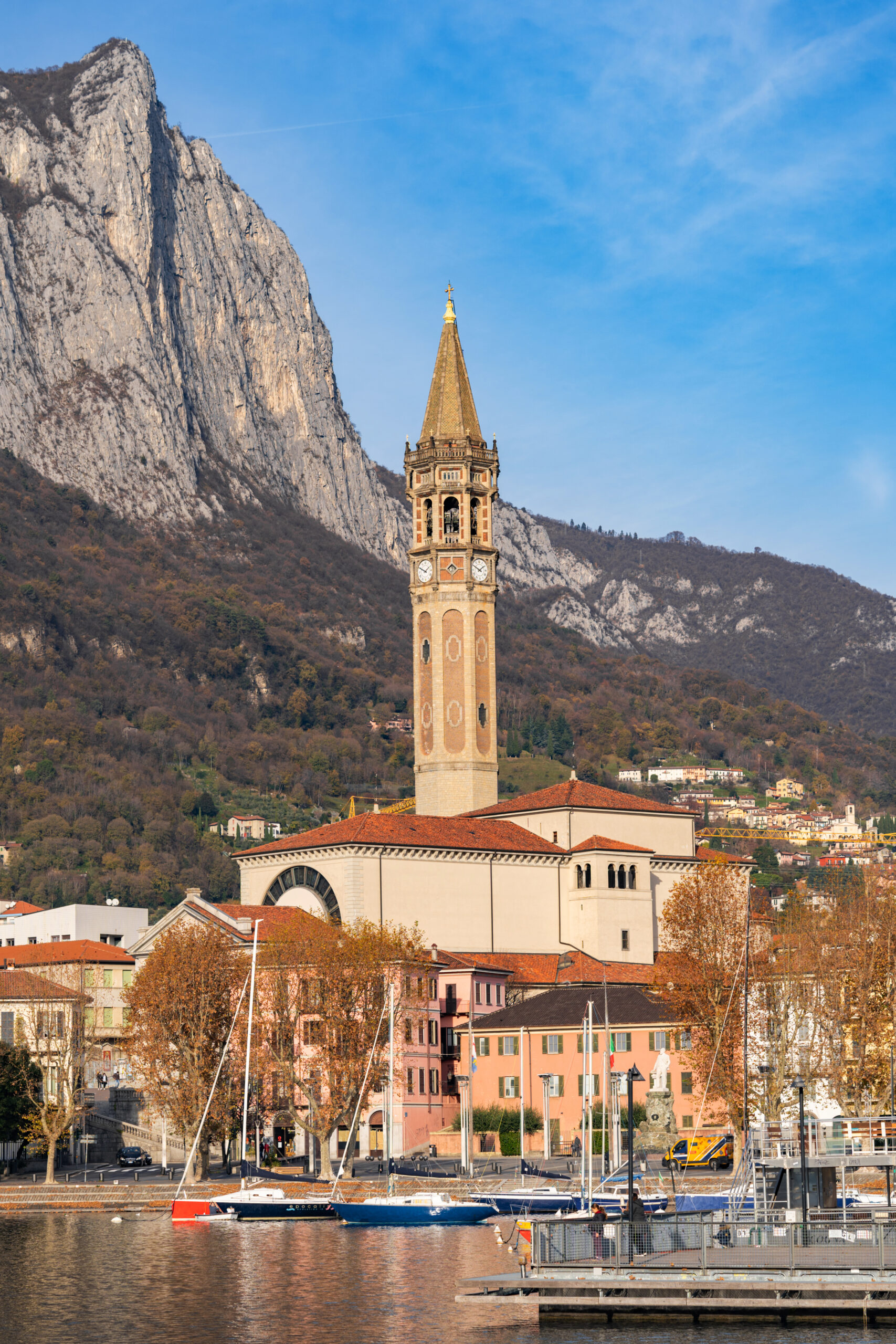 Pier and boats docked at marina on Lake Como in the harbor of the city of Lecco